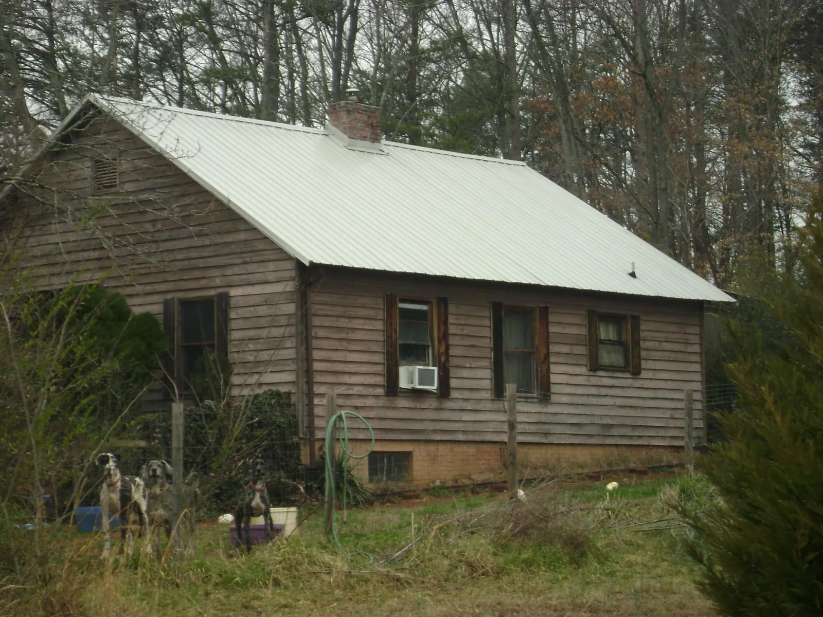 White metal roof on an old wood sided farmhouse, from a Metal Roof Installation job in Willoughby